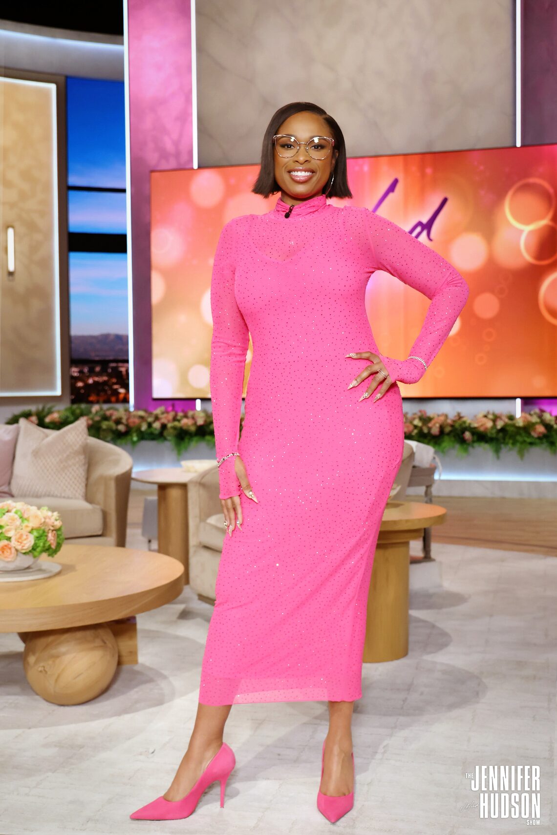 On February 9, Jennifer honored music legend Babyface in a hot pink mock neck long-sleeved gown covered in crystal sparkles. She accessorized with silver hoop earrings, silver bracelets, and a 14k white gold diamond and white quartz shank ring from J. Sheffner.