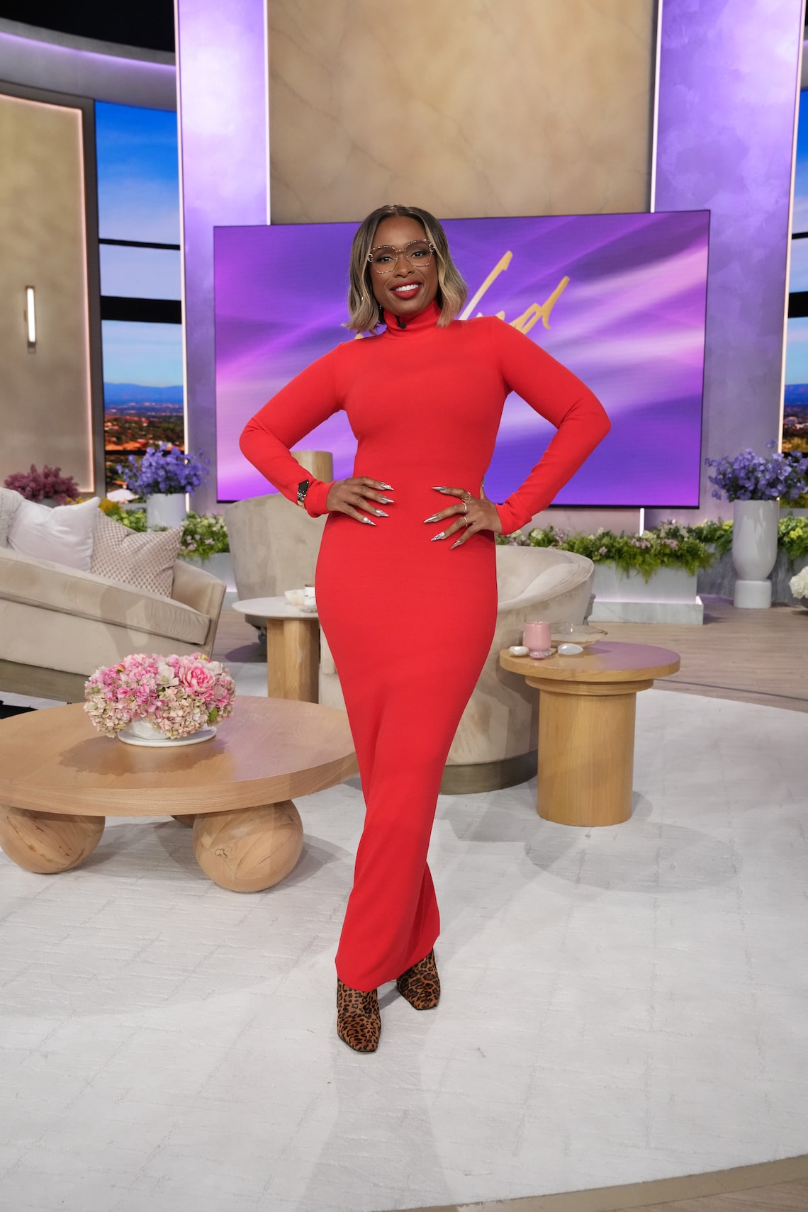 Jennifer got cozy in this bold, bright red sweater dress from Lado Bokuchava. She paired this look with leopard-print Steve Madden booties.