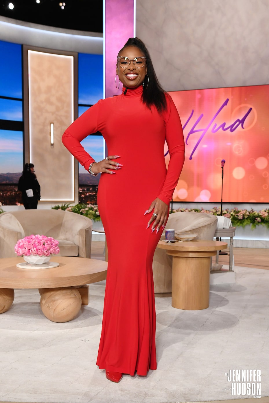 On Tuesday, June 4, Jennifer sat down with Morris Chestnut while dressed in a red, long-sleeved Norma Kamali gown with a mock turtleneck and a mermaid silhouette. She accessorized with silver jewelry and silver eyeglass frames, topping it all off with a sparkly pink manicure.